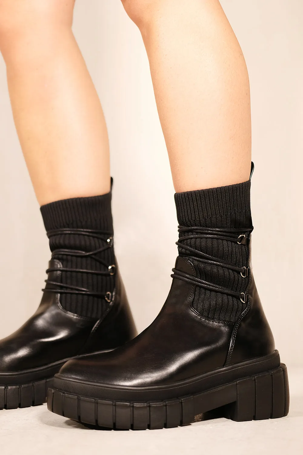 LANDRY CHUNKY SOLE ANKLE BOOTS WITH KNITTED SOCK IN BLACK FAUX LEATHER